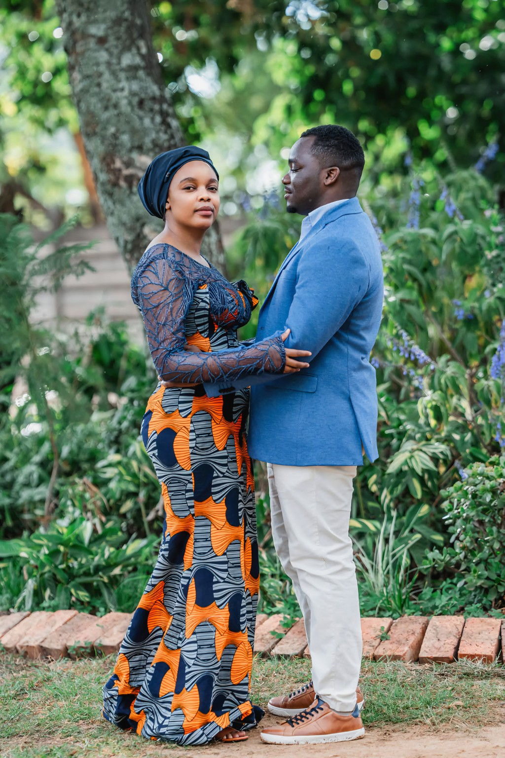 Couple standing together in a garden setting