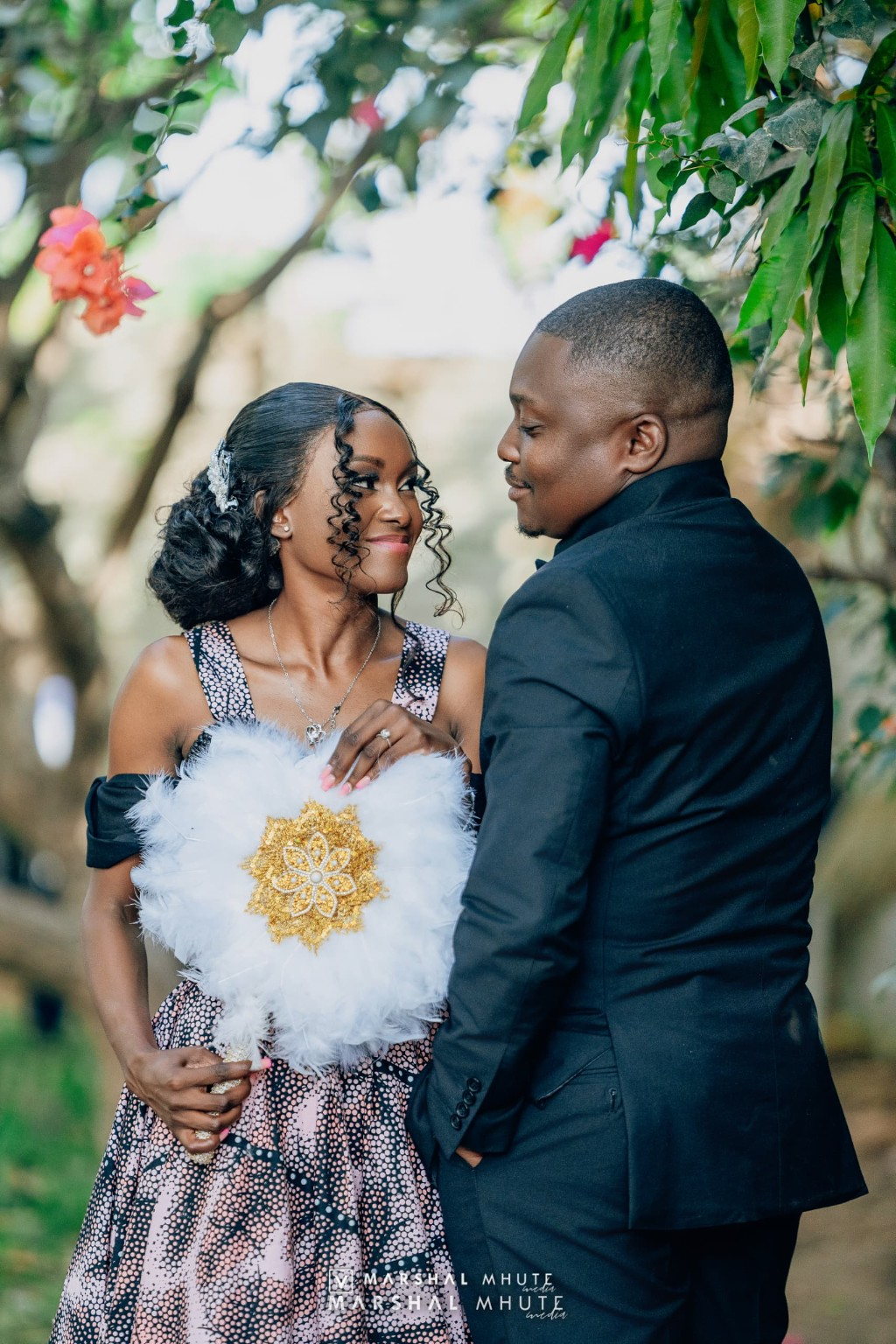 Formal couple portrait with cultural fan detail
