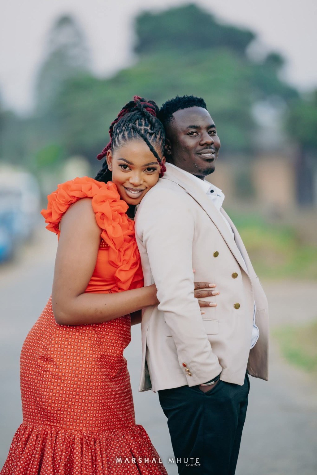 Couple embracing with calm warmth in orange and cream tones